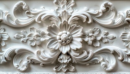 A white flower design is on a wall