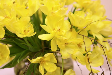 A vase filled with bright yellow flowers sits atop a table, ideal for adding a pop of color to any scene.
