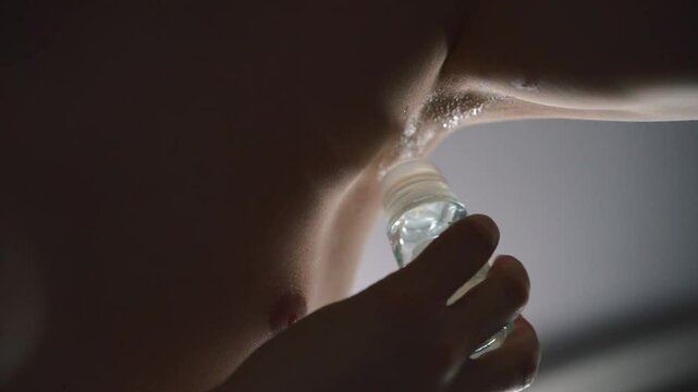 Sweaty armpits of a man.
A man smears his armpits with deodorant.
Antiperspirant.
A man's armpits stink.
Body care on a hot day