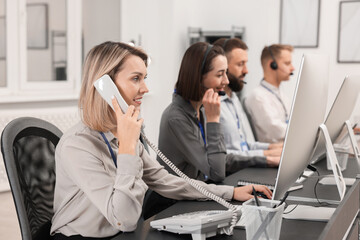 Technical support call center. Team of operators working in office