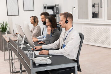 Technical support call center. Team of operators working in office