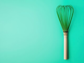Vibrant green matcha whisk on a simple background, modern nutrition trend
