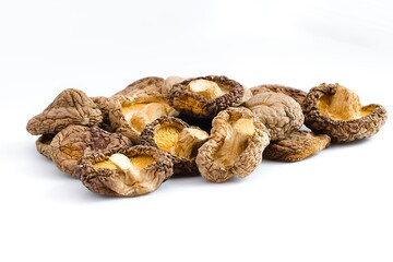 A crisp composition of dried shiitake mushrooms on a white backdrop, emphasizing their natural texture and earthy appeal.