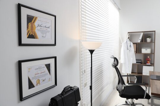 Framed doctor's certificates on wall in medical office