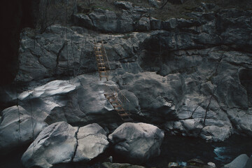 a vertical shot of a beautiful waterfall on a rocky mountain