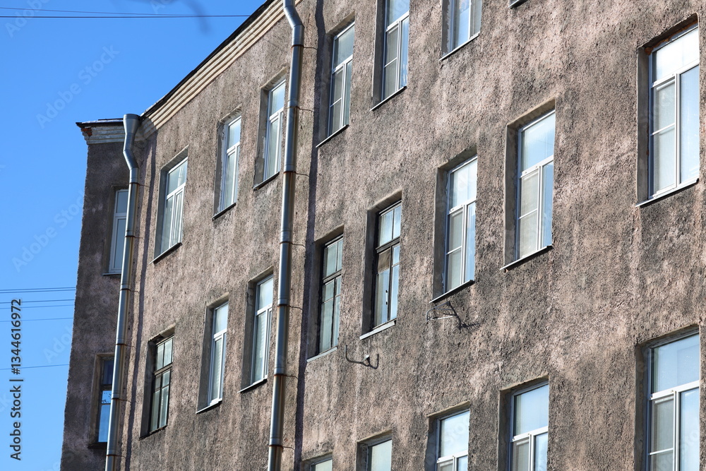 Poster A modern building with a clock tower, suitable for use in architecture or cityscape images.