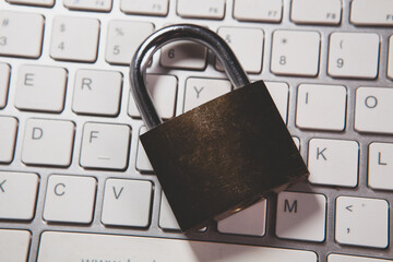 padlock with a laptop computer on a wooden background.