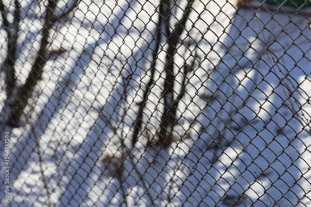 Poster A snowy day scene with a close-up view of a chain link fence.