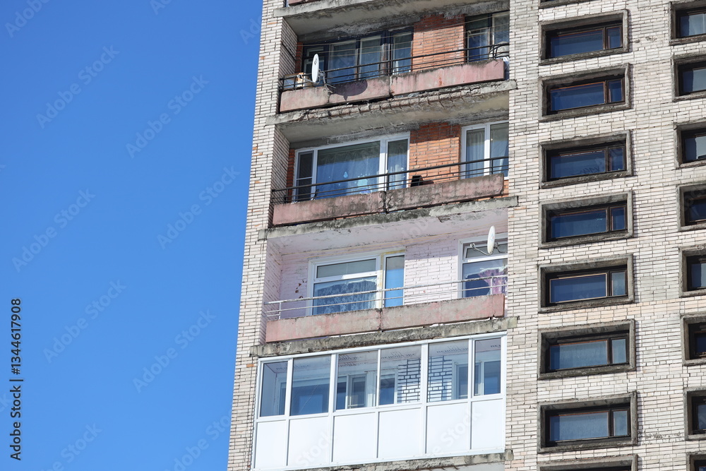 Poster A tall building with a clock on its side, often used in cityscape or architecture scenes.