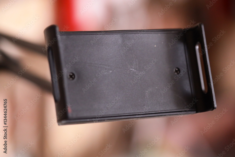 Poster A close-up view of a cell phone in a holder, suitable for use in technology-related contexts.