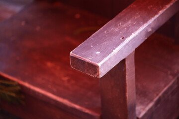 Close-up of a wooden bench seat.