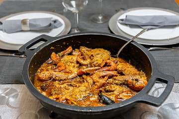 Close-up of zarzuela de marisco, a traditional Spanish seafood stew with shrimp, crab, mussels, and fish in a rich sauce.