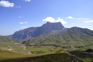 A perfect view of the harsh rocks and green plains from the peak of Shahdag in the Caucasus Mountains