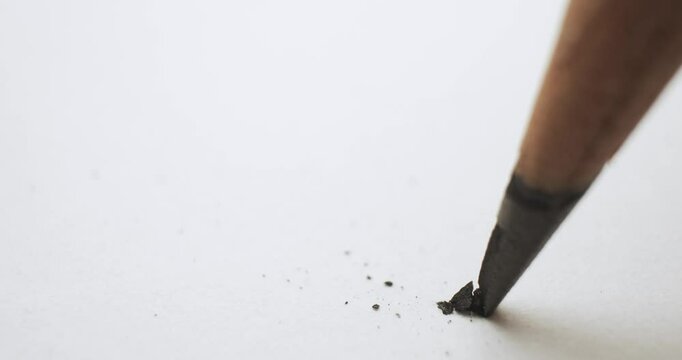 Close up of a pencil with the graphite tip cracking under pressure. Problem of a pencil lead breaking symbolizing a stress or crisis at work or school, frustration, or a simple mistake.