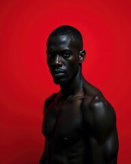 Portrait of a muscular Black man against a red background. Studio shot.