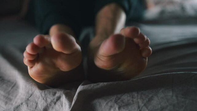 Close-up of men's feet.
A man massages his feet.
Tired feet.
Health problems and tired feet in a man