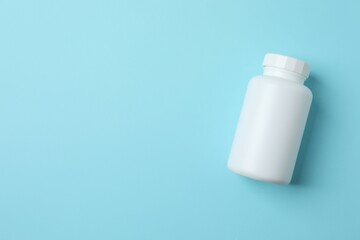 White bottle on blue background, top view