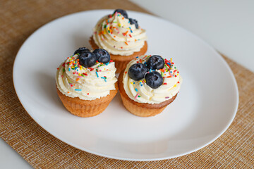 Cupcakes on a white platter. Confectionery products. Food and beverages. Sweet pastries.