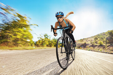 Female cyclist riding a bicycle fast