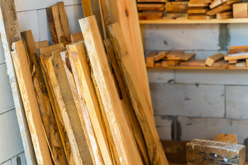 Warehouse in a carpenter's workshop with various boards and wooden materials for handicrafts. Wooden blanks in the workshop
