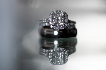 A sparkling diamond engagement ring and wedding band reflected elegantly