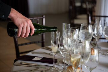 Champagne is poured into a flute at an elegant wedding reception