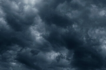 Dramatic stormy sky background. Dark fluffy cloudy sky. Moody spooky cloudscape. Rainy season.