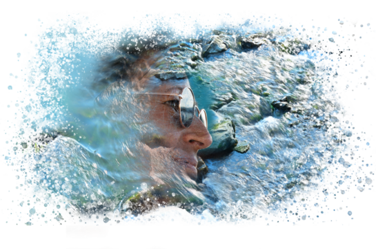 Face of a woman with water drops and splashes of a clear blue stream washed by the flow of the waterfall in a natural clean environment.