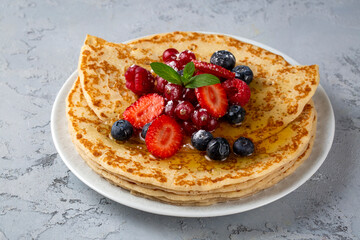 Healthy summer breakfast, homemade classic crepe with fresh fruit and honey