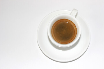 Fresh Aromatic Black Coffee in White Cup on White Background. Cafe.