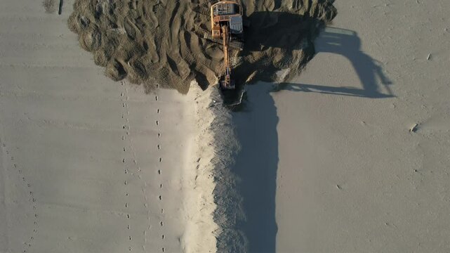 Bulldozer in Versilia, removal of storm surge protection, aerial video documentation.