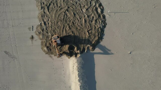 Bulldozer in Versilia, removal of storm surge protection, aerial video documentation.