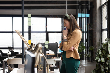 Businesswoman in office analyzing data on board, planning project strategy, copy space