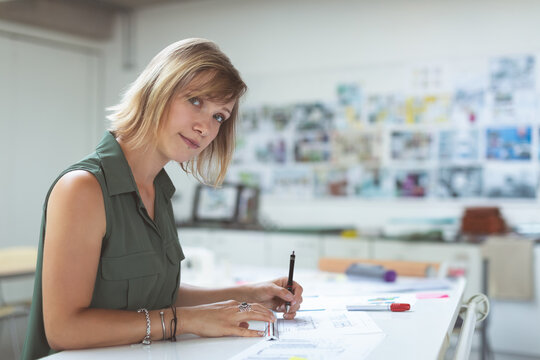 Architectural designer sketching blueprints at office, focused on creative project, copy space