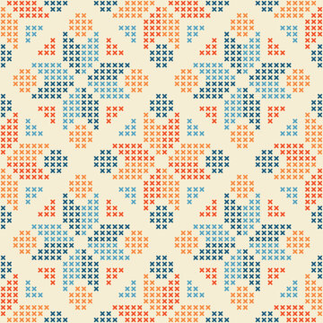 Cross stitch embroidery seamless pattern with ornamental design featuring orange, blue, and red stitches on cream background