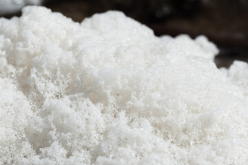 Macro photograph showing white foam textures with a bright appearance