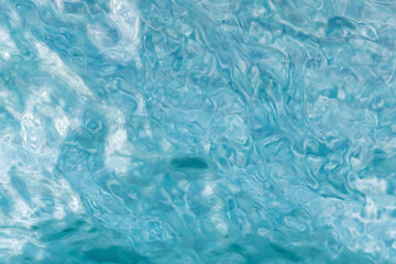 Abstract background with textured and rippled surface of blue water