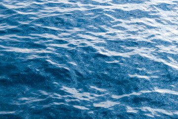Calm ocean scene showcasing the interplay of sunlight on rippling water