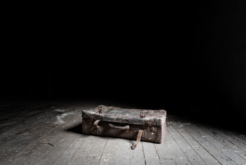 Old suitcase abandoned on the attic floor