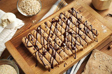 Homemade snack bars made with whey protein powder, oat flakes, sesame tahini, maple syrup, cinnamon and vanilla