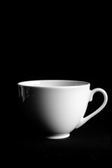 White coffee cup isolated on a black background