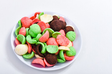 colorful cereals on a plate isolated on white background