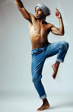 Portrait of a young man in studio dancing modern dance on toe tips