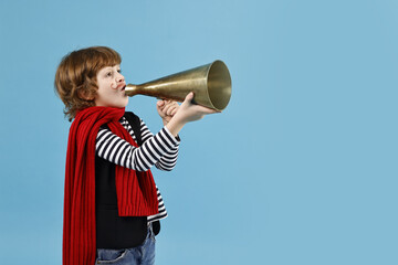 Cute boy in mime costume shouting in megaphone on light blue background, space for text. Surprise...