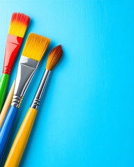 Colorful paintbrushes on blue background