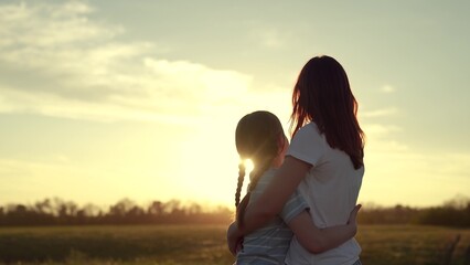 mother daughter happy family, woman kid happy family hugging, Mother Daughter Embracing Sunset, Serene Evening Countryside, Warm Hug Nature Glow, Family Love Under Twilight Sky, Peaceful, Moment