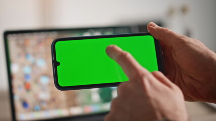 Freelancer finger tapping mockup smartphone in horizontal position home closeup