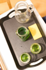 Glass jars with green liquid