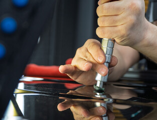 Removal of dents without painting. PDR technology for car body repair. PDR. The mechanic at the...