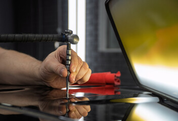 Removal of dents without painting. PDR technology for car body repair. PDR. The mechanic at the auto shop with tools to repair dents in car body. Body repair close-up.